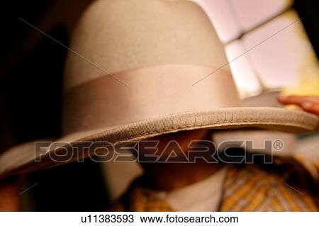 Child hides under a large hat View Large Photo Image Stock Image - Child hides under a large hat. Fotosearch