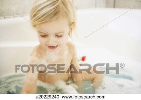 Stock Image - Child in bathtub. Fotosearch