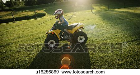 Child riding mini quad bike View Large Photo Image Stock Photo - Child riding mini quad bike. Fotosearch