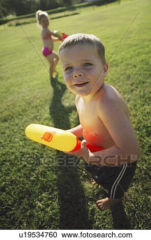 Children playing in the park with water pistols View Large Photo Image Stock Image - Children playing in the park with water pistols. Fotosearch