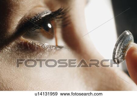 Close-up of woman putting in a contact lens View Large Photo Image Stock Photo - Close-up of woman putting in a contact lens. Fotosearch