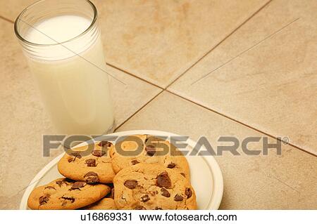 Cookies and glass of milk on work surface View Large Photo Image Stock Image - Cookies and glass of milk on work surface. Fotosearch
