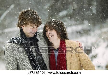 Couple hugging in the snow View Large Photo Image Stock Photograph - Couple hugging in the snow. Fotosearch