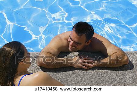 Stock Photo - Couple talking near the pool. Fotosearch