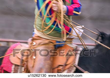 Stock Image - Cowboy using lasso. Fotosearch