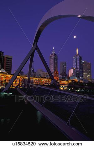 Curved span of bridge with city skyline in background View Large Photo Image Stock Image - Curved span of bridge with city skyline in background. Fotosearch