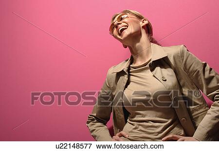 Stock Photo - Female model laughing out loud. Fotosearch
