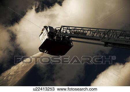 Firemen on ladder putting out fire View Large Photo Image Stock Image - Firemen on ladder putting out fire. Fotosearch