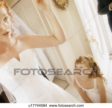 Picture - Flower girl admires the bride. Fotosearch