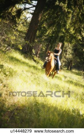 Stock Photo - Girl riding horse. Fotosearch