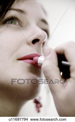 Lady applying lipstick View Large Photo Image Picture - Lady applying lipstick. Fotosearch