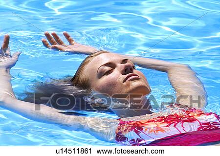 Lady floating in water View Large Photo Image Stock Image - Lady floating in water. Fotosearch