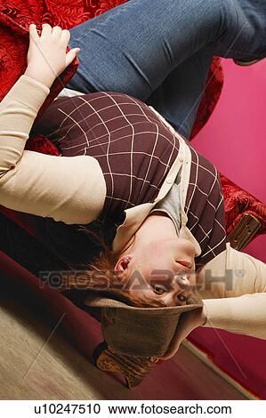Lady upside down in chair View Large Photo Image Stock Image - Lady upside down in chair. Fotosearch