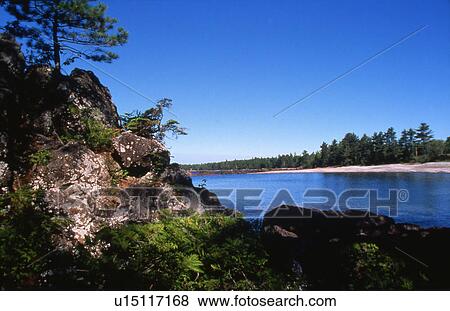Stock Photo - Lake and rocky shore. Fotosearch