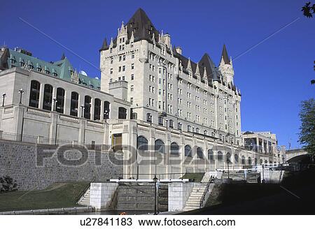Stock Image - Large building alongside a canal. Fotosearch