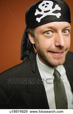 Man having fun playing a practical joke as a wacky pirate View Large Photo Image Stock Photo - Man having fun playing a practical joke as a wacky pirate. Fotosearch