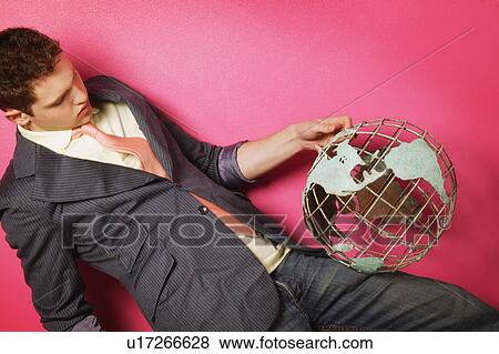 Stock Photo - Man holding globe. Fotosearch