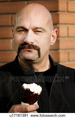 Stock Image - Man holding ice cream. Fotosearch