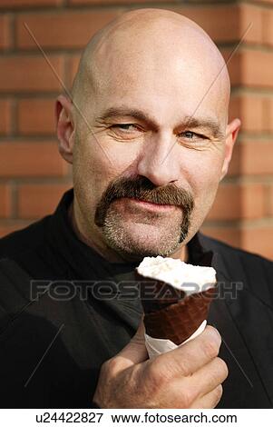 Stock Photo - Man holding ice cream. Fotosearch