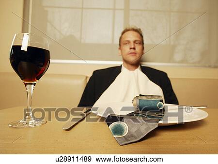 Stock Photo - Man in a restaurant famished. Fotosearch