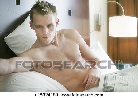 Man in bed relaxing View Large Photo Image Stock Photo - Man in bed relaxing. Fotosearch