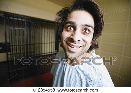 Man locked up in psychiatric jail cell View Large Photo Image Stock Photo - Man locked up in psychiatric jail cell. Fotosearch