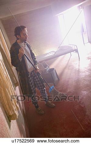 Man mops the floor View Large Photo Image Stock Photo - Man mops the floor. Fotosearch