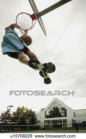 Stock Photo - Man playing basketball. Fotosearch