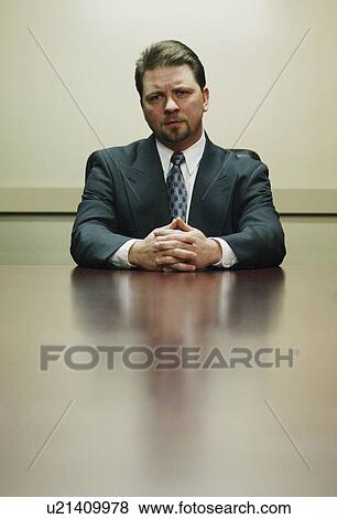 Man sitting in boardroom View Large Photo Image Stock Photo - Man sitting in boardroom. Fotosearch