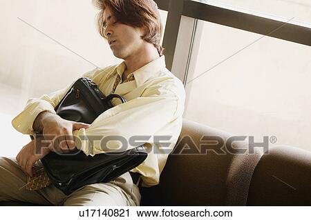 Man sleeps in airport View Large Photo Image Stock Image - Man sleeps in airport. Fotosearch