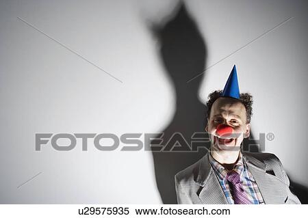 Man wearing a clown's nose and hat View Large Photo Image Stock Photography - Man wearing a clown's nose and hat. Fotosearch