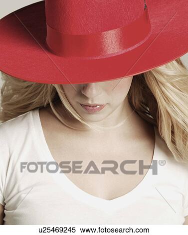 Stock Photography - Modeling a red hat. Fotosearch