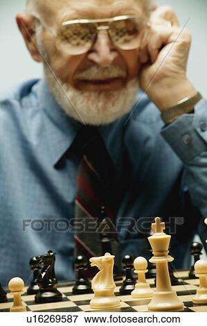Stock Photo - Playing a game of chess. Fotosearch