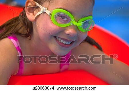 Picture - Portrait of young girl in swimming pool. Fotosearch