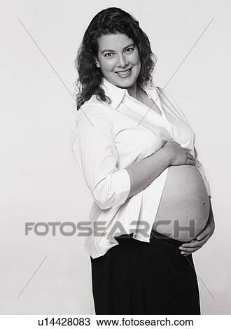 Stock Image - Pregnant woman with belly exposed. Fotosearch