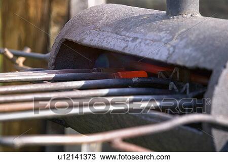 Preparing cattle branding irons View Large Photo Image Stock Image - Preparing cattle branding irons. Fotosearch