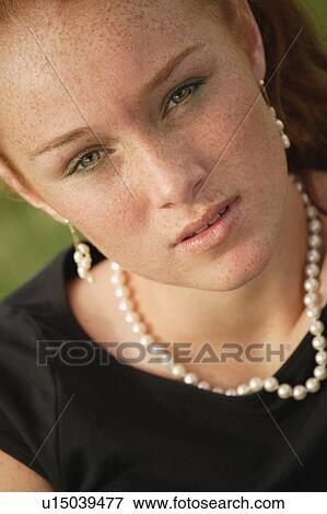 Stock Photo - Pretty teenage girl with red hair. Fotosearch
