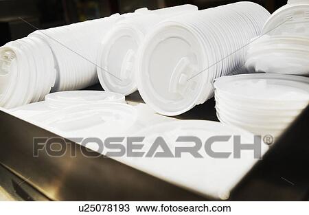 Stock Image - Rows of hot beverage lids. Fotosearch