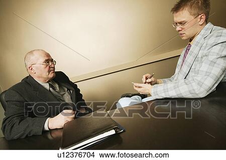 Senior giving junior instructions View Large Photo Image Picture - Senior giving junior instructions. Fotosearch