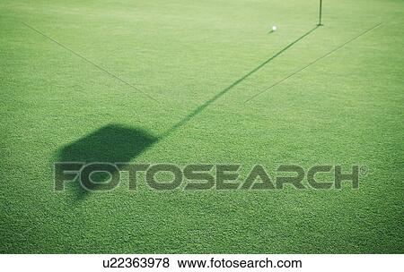 Stock Photo - Shadow of flag on the green. Fotosearch