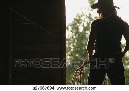Picture - Silhouette of a cowgirl. Fotosearch