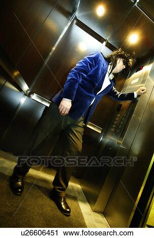 Stock Image - Silly businessman in elevator. Fotosearch