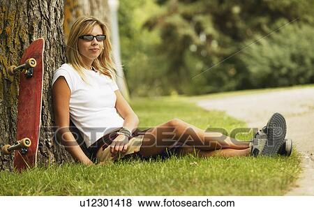 Skateboarder taking a break View Large Photo Image Stock Photo - Skateboarder taking a break. Fotosearch