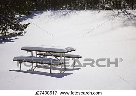 Snow-covered picnic seating View Large Photo Image Stock Photo - Snow-covered picnic seating. Fotosearch