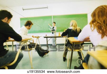 Picture - Teacher teaching in classroom. Fotosearch