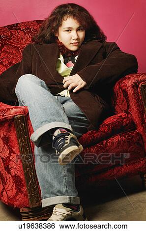 Stock Photograph - Teen girl sitting in chair. Fotosearch
