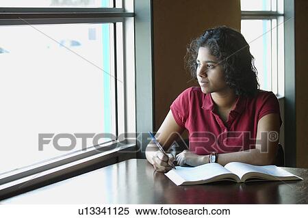 Stock Photography - Teenage female student pondering. Fotosearch