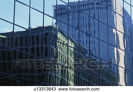 Stock Image - Two buildings reflected in another. Fotosearch