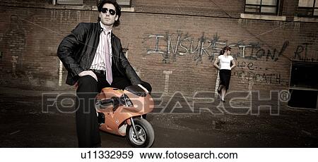 Urban couple and small bike View Large Photo Image Stock Photo - Urban couple and small bike. Fotosearch
