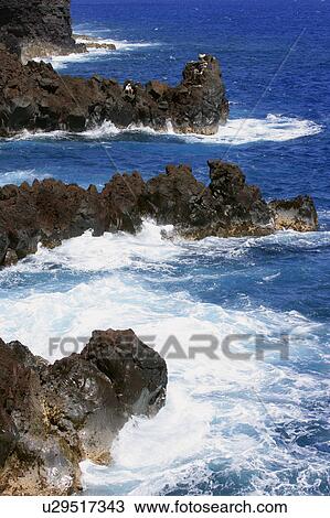 Stock Image - Waves on cliff shore. Fotosearch